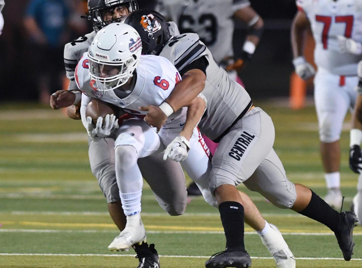 Buchanan’s Colton O’Toole, center, is tackled by Central’s Aidan Chavez, right, Friday, Oct. 7, 2022 in Fresno. Buchanan won 49-41.