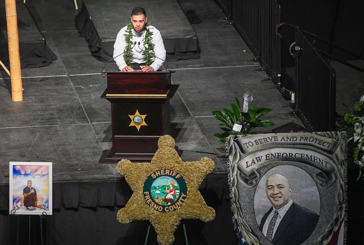Robert Scanlan gives a eulogy for his father, Fresno County Sheriff’s Office correctional officer Toamalama Scanlan, during a memorial service at the Save Mart Center in Fresno on Monday, Oct. 25, 2021.