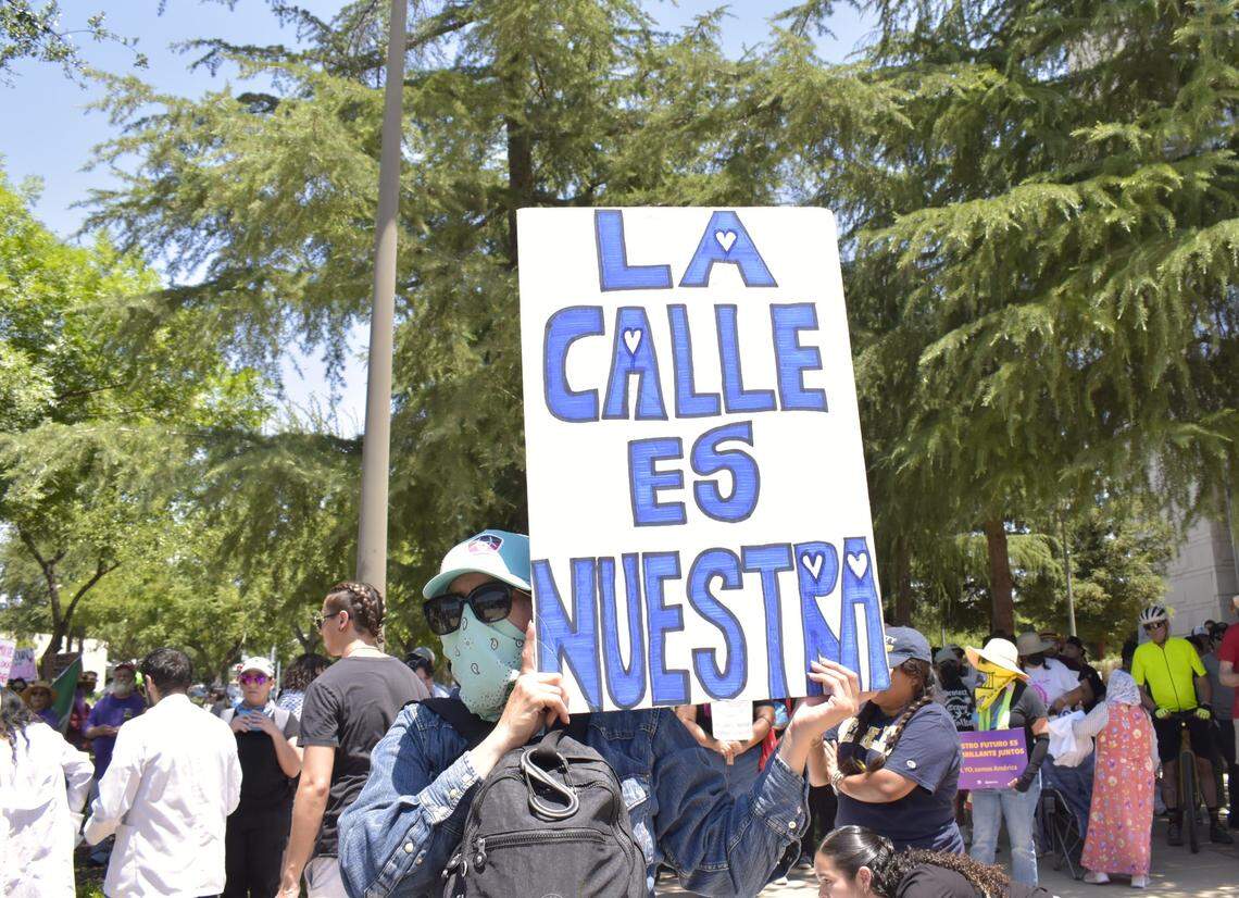 A protestor holds a Spanish-language sign that translates to “the street is ours” Monday, June 9, 2025, during a downtown Fresno protest prompted by recent federal immigration raids.