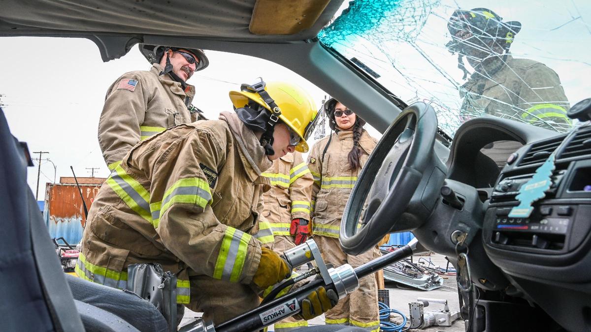 Fresno Fire Explorer Cece Bispo uses a hydraulic extrication tool on a vehicle during the Fresno Fire Department’s annual “Firefighter for a Day” event where citizens can get an inside look at the job of a firefighter, at the department’s training grounds in Fresno on Saturday, Oct. 22, 2022.