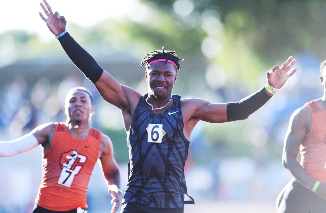 Clovis High’s Nathan Johnson, center, takes first place in the 100 at the Central Section Masters held at Buchanan High School Saturday, May 21, 2022 in Clovis.