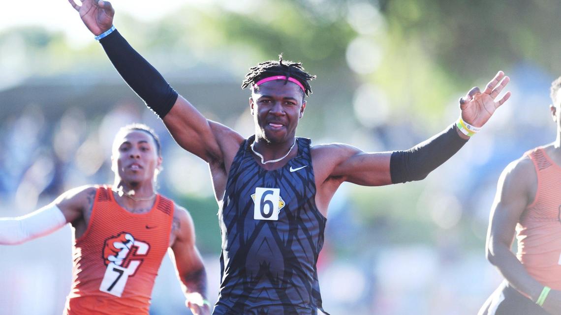 Clovis High’s Nathan Johnson, center, takes first place in the 100 at the Central Section Masters held at Buchanan High School Saturday, May 21, 2022 in Clovis.
