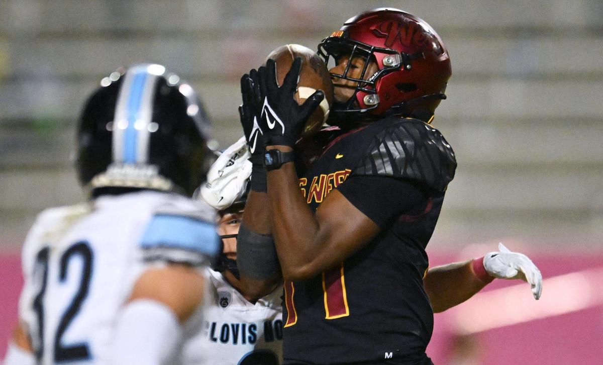 Clovis West’s Landon Wright makes the catch covered by Clovis North’s defense in TRAC action Friday, Oct. 13, 2023, in Clovis.
