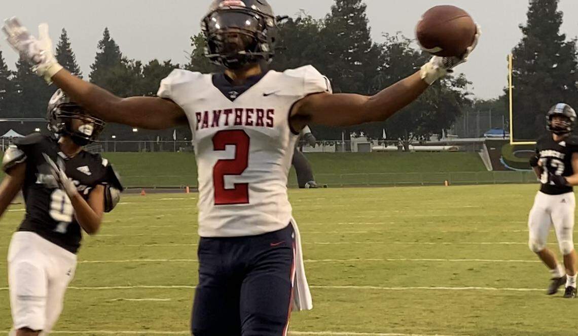 San Joaquin Memorial wide receiver TJ Hall picks up a touchdown against Clovis North at Veterans Memorial Stadium on Friday, Aug. 20, 2021.