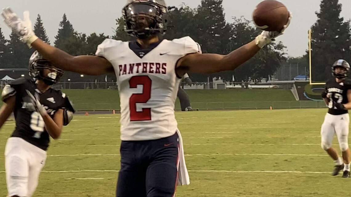 San Joaquin Memorial wide receiver TJ Hall picks up a touchdown against Clovis North at Veterans Memorial Stadium on Friday, Aug. 20, 2021.