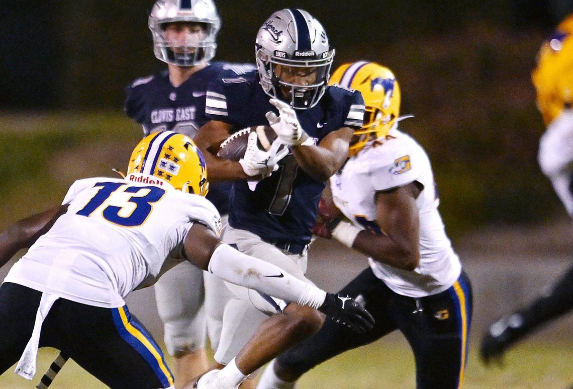 Clovis East running back Lindsey Graves, center, finds a hole in the Grant Union defense Friday, Sept. 13, 2024 in Clovis.