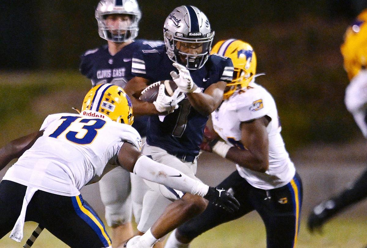 Clovis East running back Lindsey Graves, center, finds a hole in the Grant Pacers defense Friday in Clovis.