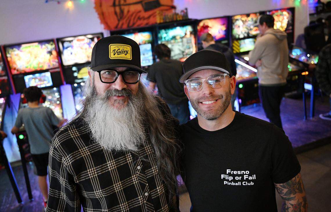 Summer Fox co-owner Jason Hatwig, left, and Fresno Flip or Fail Pinball Club's Vaughn Jordan, right, partnered to hold a pinball pop-up at Summer Fox Saturday, Dec. 6, 2025 in Clovis.