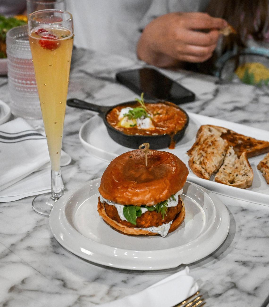 Foods like the falafel burger are tasted along with plenty of mimosas during a test run for The Breakfast Bar in Clovis on Tuesday, May 9, 2023.