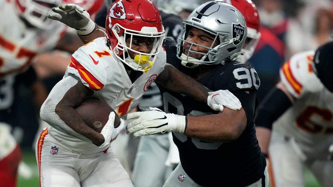 Kansas City Chiefs running back Jerick McKinnon runs with the ball past Las Vegas Raiders defensive tackle Jerry Tillery during the second half of an NFL game Saturday, Jan. 7, 2023, in Las Vegas.