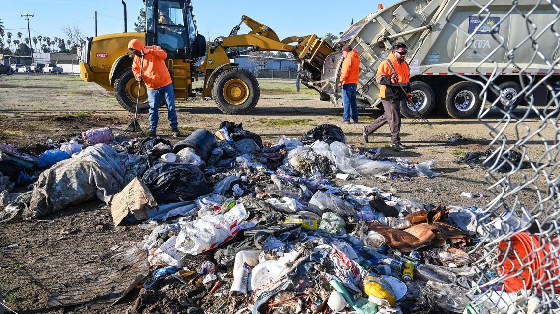 A crew with Fresno’s Homeless Assistance Response Team (HART) begins a homeless camp cleanup operation behind several shelters on Parkway Drive in Fresno on Wednesday, Feb. 1, 2023