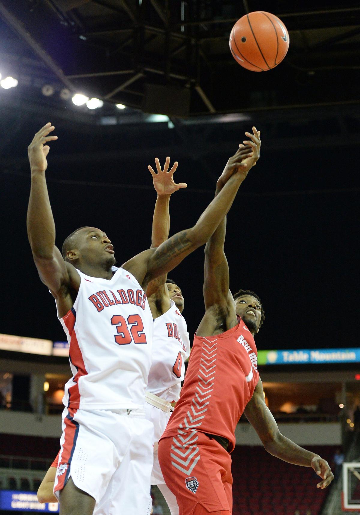 Fresno State senior Nate Grimes, left, and New Mexico’s Corey Manigault battle for a loose ball in the first half of the Bulldogs’ 82-77 victory over the Lobos at the Save Mart Center in Fresno on Saturday, Feb. 1, 2020.
