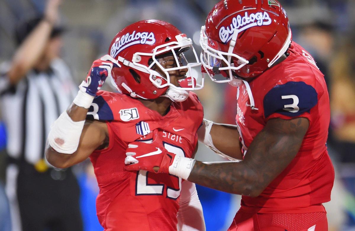 Fresno State safty Juju Hughes, left, celebrates a fourth-quarter interception with linebacker Mykal Walker, right, Saturday, Oct. 26, 2019 in Fresno.