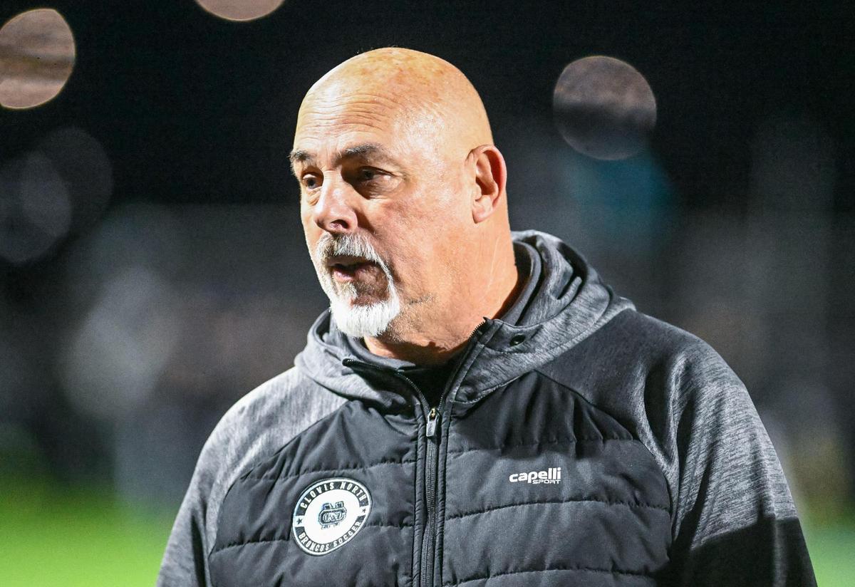Clovis North soccer coach John Spurgeon talks to the team following their defeat against Edison in their Division 1 soccer final at Clovis North on Thursday, Feb. 27, 2025.