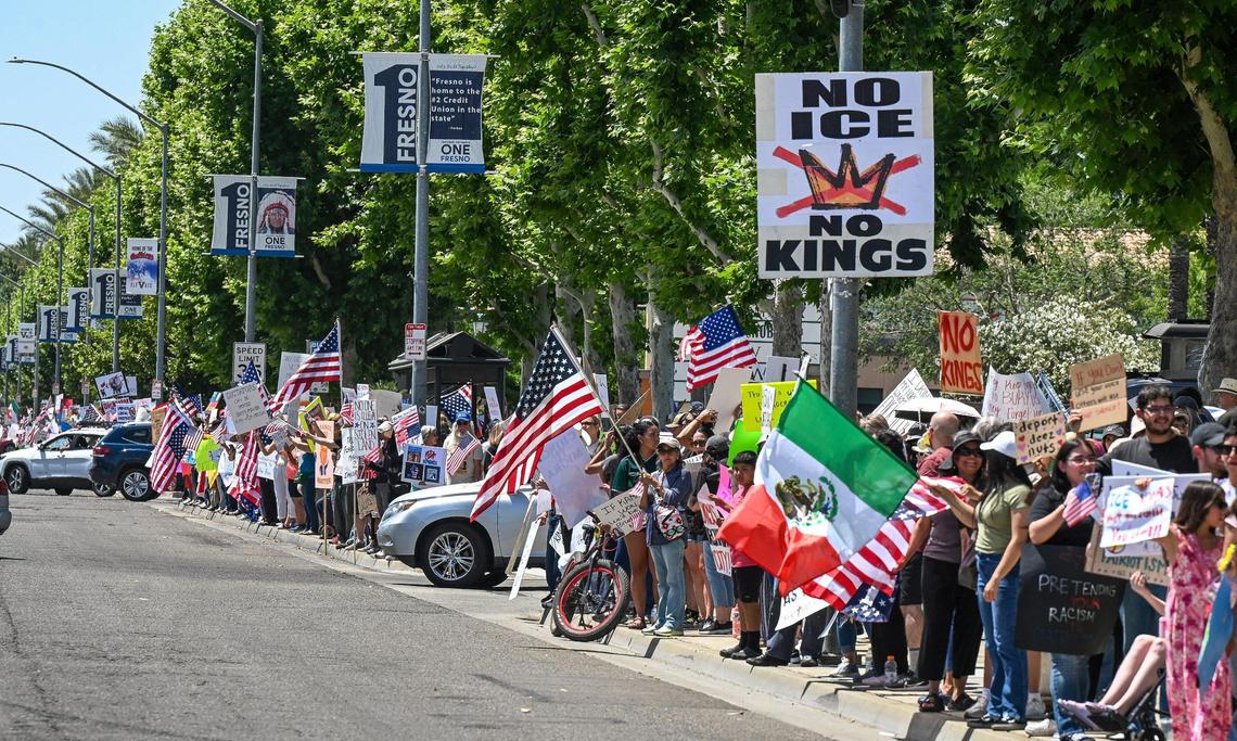 Hundreds of protesters line Blackstone Avenue at Nees near River Park shopping center during a no kings protest against President Donald Trump’s policies in Fresno on Saturday, June 14, 2025.