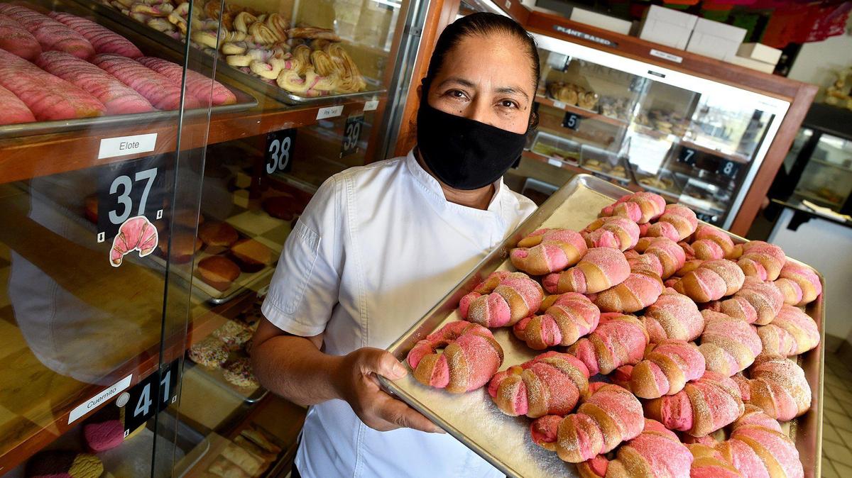 Eugenia Garcia, owner of Panderia Cafe Oaxaca in Clovis, holds a tray of freshly baked pastries on Feb. 15.