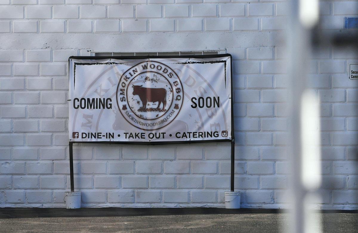 A banner for Smoking Woods BBQ is seen in the parking lot adjacent to Tioga-Sequoia Brewing Company’s Beer Garden on Fulton. Photographed Thursday, July 14, 2022 in Fresno. Oakland-based Smoking Woods BBQ will be parking a trailer in the lot and serving smoked barbecue.