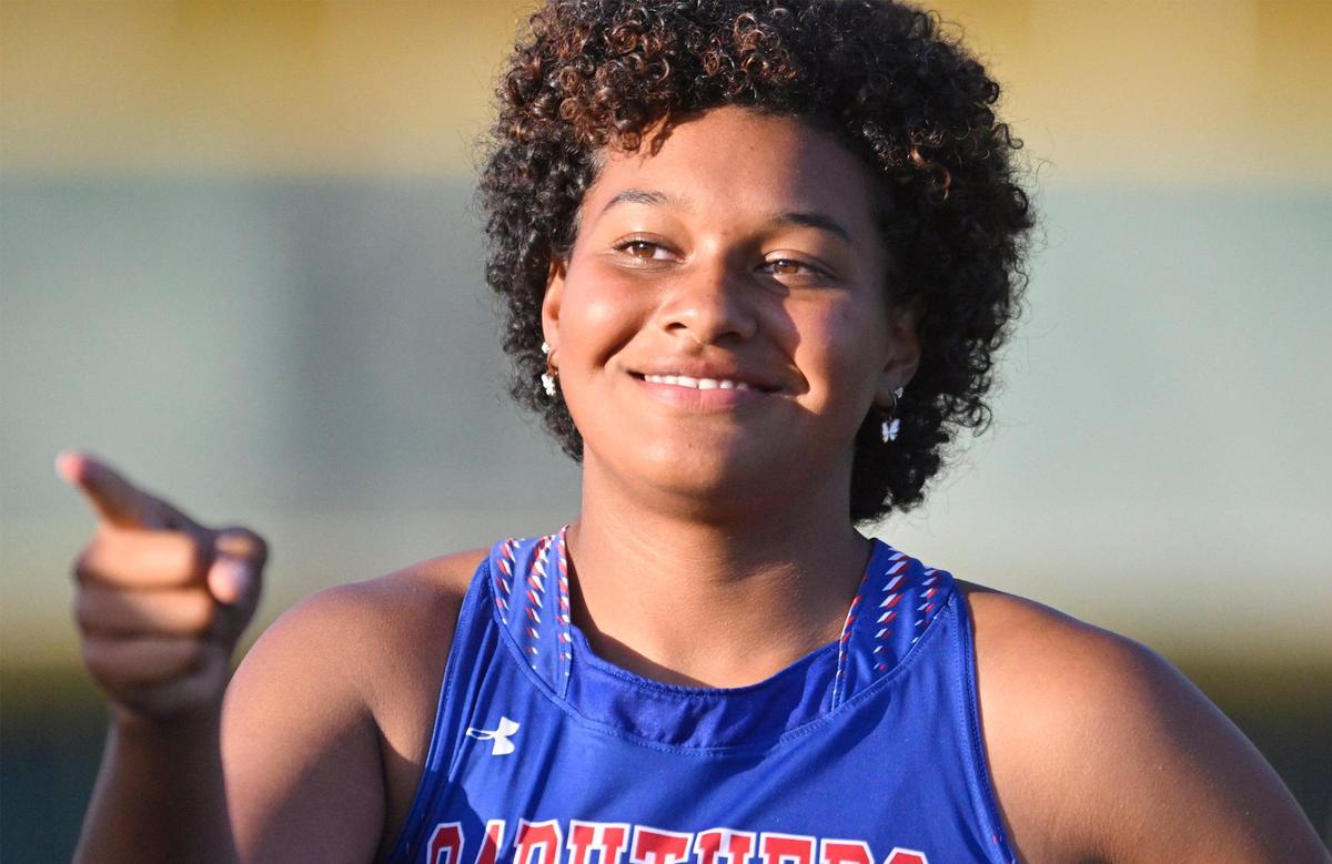 Caruthers’ Nailea Fields laughs with her coach between throws at the Girls Discus finals Saturday, May 27, 2023 in Clovis.