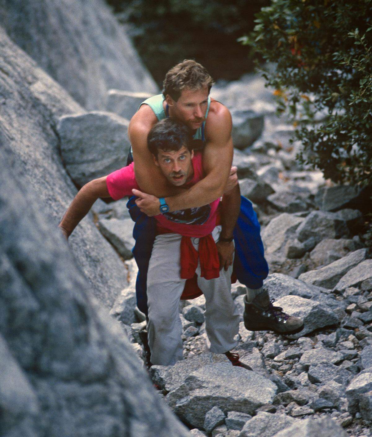 Mike Corbett carries Mark Wellman to the beginning of the Shield Route on El Capitan, July 1989. Wellman became the first paraplegic climber to ascend the granite monolith during an eight-day climb.