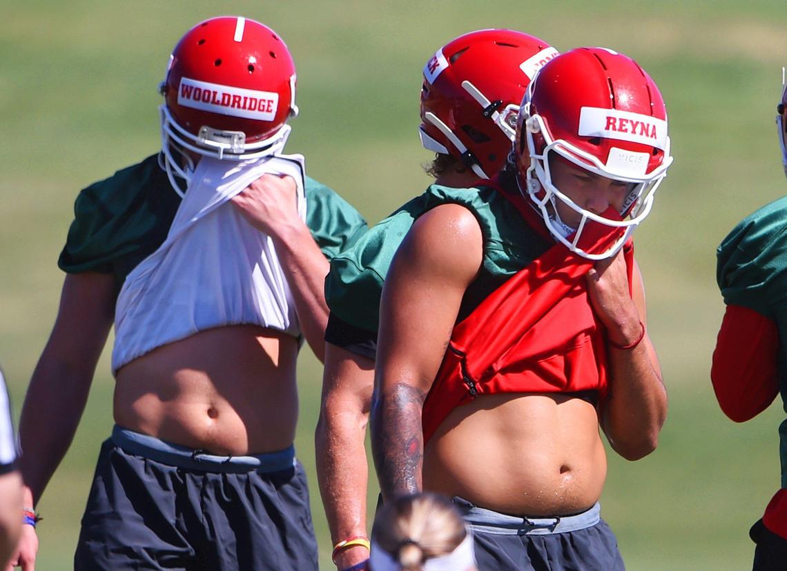 Fresno State quarterbacks Ben Wooldridge, left, and Jorge Reyna, right, work up a sweat on the first day of preseason camp Friday, Aug. 2, 2019.