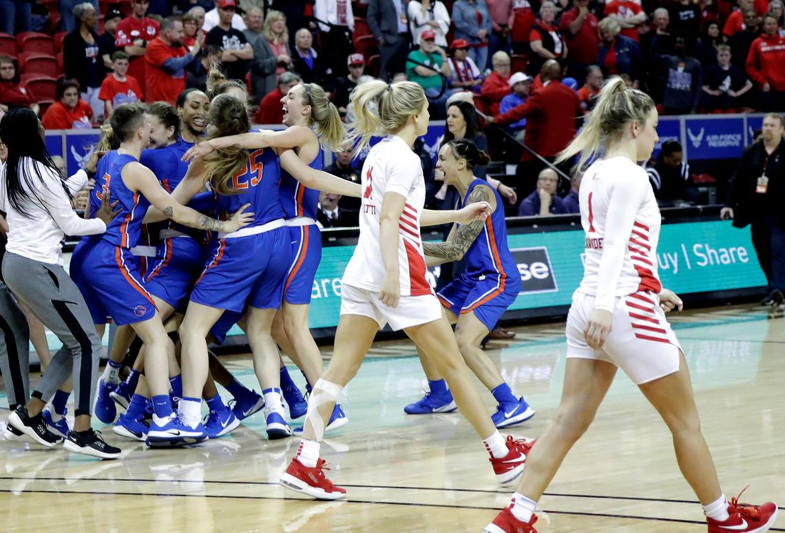 Fresno State’s Maddi Utti, left, and Haley Cavinder, right, walk off the court as Boise State celebrates their 80-76 overtime win over the Bulldogs in the 2020 Mountain West Tournament championship game last March in Las Vegas.