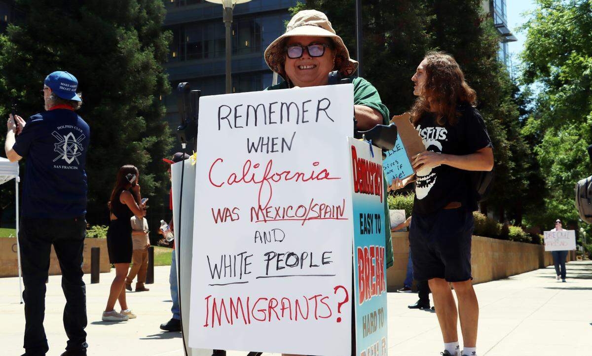 This woman was among scores of protesters who showed up a noon rally in front of the federal courthouse in downtown Fresno to protest the immigration raids in Los Angeles.