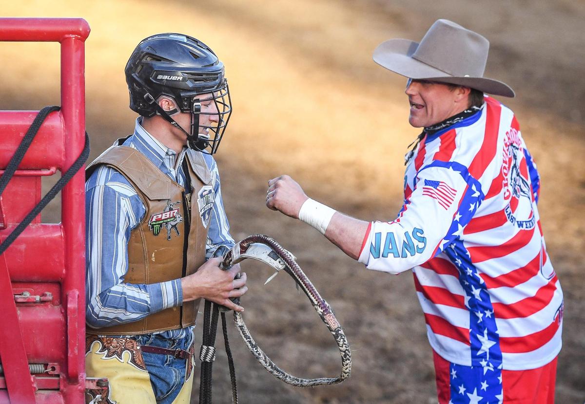 Jesse Petri, left, is congratulated after his ride on Gin n’ Sin in the second section of bull riding during the Professional Bull Riders event on the opening day of the Clovis Rodeo on Wednesday, April 20, 2022.