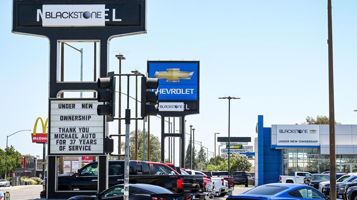 The former Michael Cadillac and Chevrolet car dealerships on Blackstone Avenue at Bullard in Fresno are shown with temporary signage covering the “Michael” signs on Monday, June 27, 2022. The dealerships, that were owned by Mike Rosvold for nearly four decades, were sold to Steve Cornelius and will now have the name Blackstone.