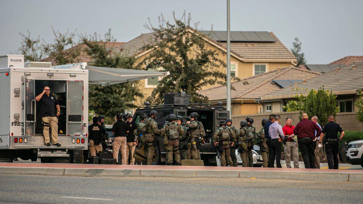 Fresno police SWAT team gathers near Maple and Copper avenues on Monday, Aug. 16, 2021, as it works to end a standoff with a suspect in a robbery and carjacking.