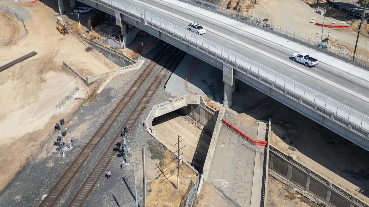The historic Belmont Avenue subway bridge, built in 1932, is still visible below the new overpass bridge, or grade separation, which is now open.