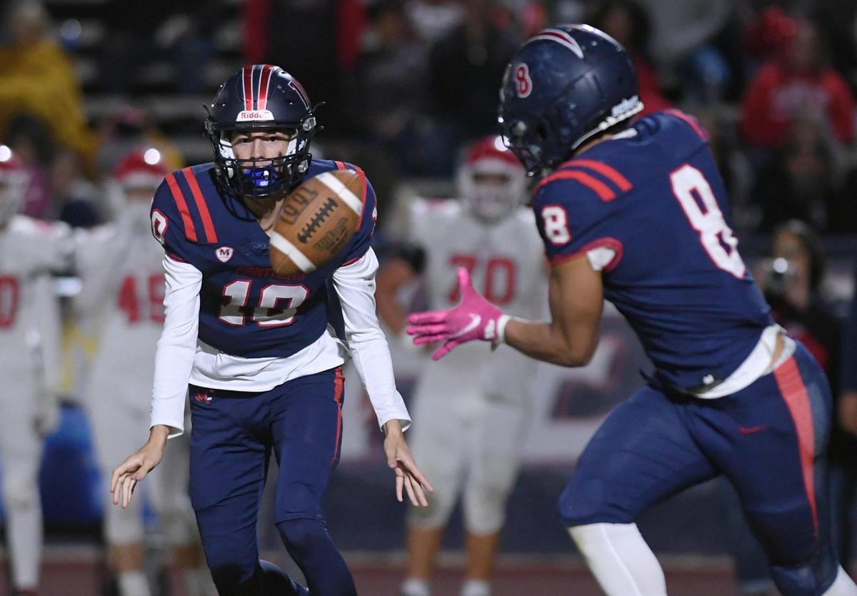San Joaquin Memorial quarterback Carson Dean, left, pitches the ball to Brandon Ramirez, right, against Sanger Friday, Oct. 28, 2022 in Fresno. Memorial dominated Sanger to a 56-21 championship win in the County/Metro Athletic Conference.