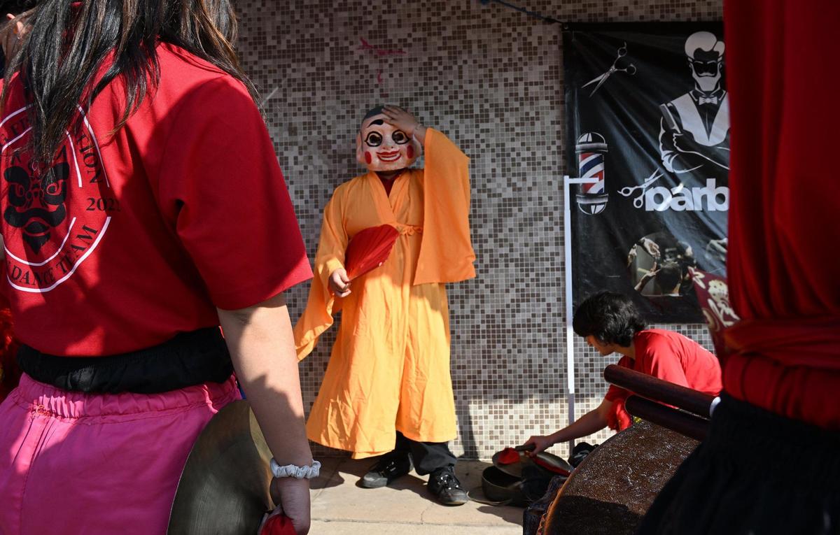 A character from the Chinese New Year Lion Dancers prepares to enter a business Saturday morning, Jan. 25, 2025 in Fresno’s Chinatown.