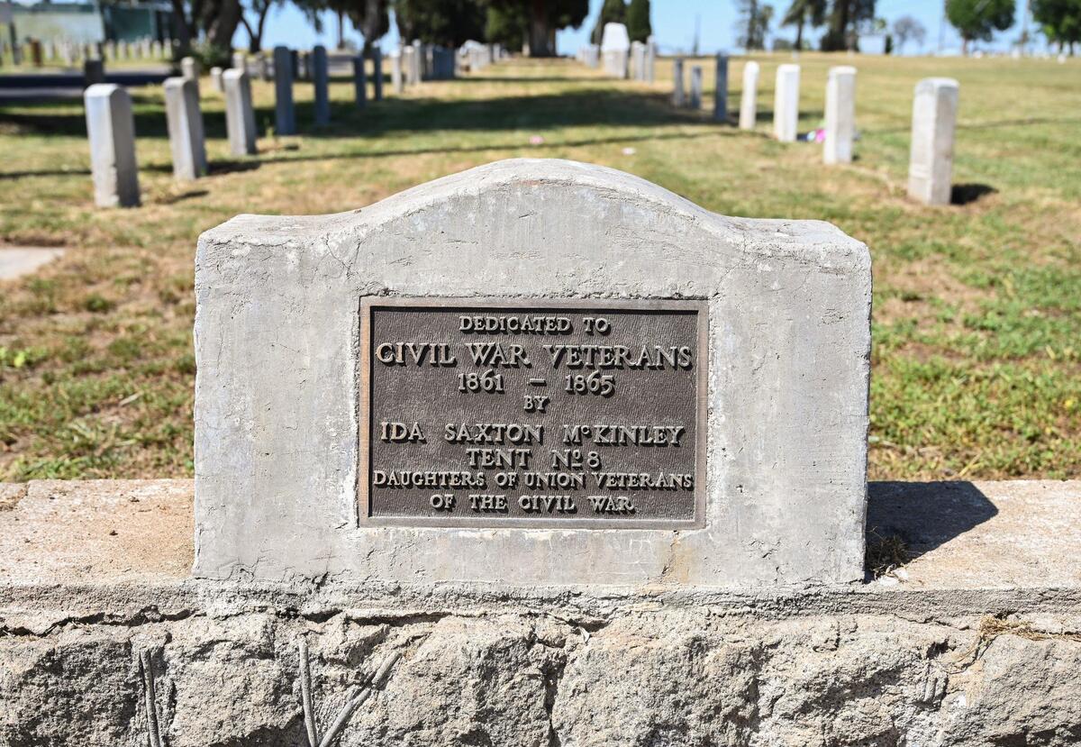 A plaque dedicated to Civil War Veterans at the Veterans Liberty Cemetery on Belmont Avenue near Hughes is shown on Friday, April 28, 2023. The cemetery started in 1896 had been intended for veterans of conflicts dating back to the Civil War.