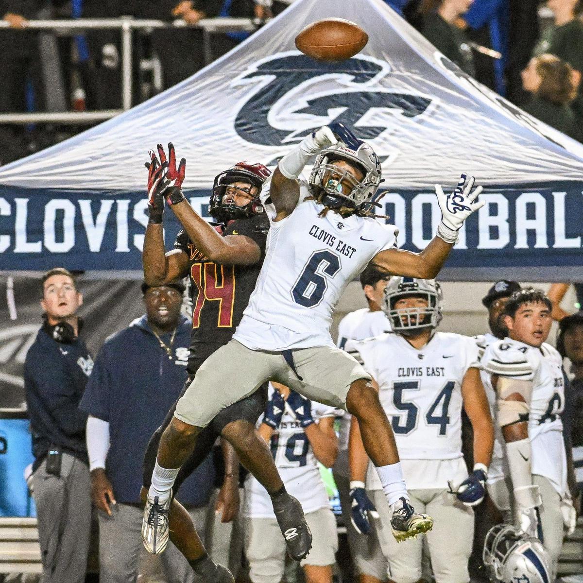 Clovis East’s Donyell Booker, right, breaks up a pass to Clovis West’s Landon Wright during their game at Veterans Memorial Stadium in Clovis on Friday, Oct. 6, 2023.