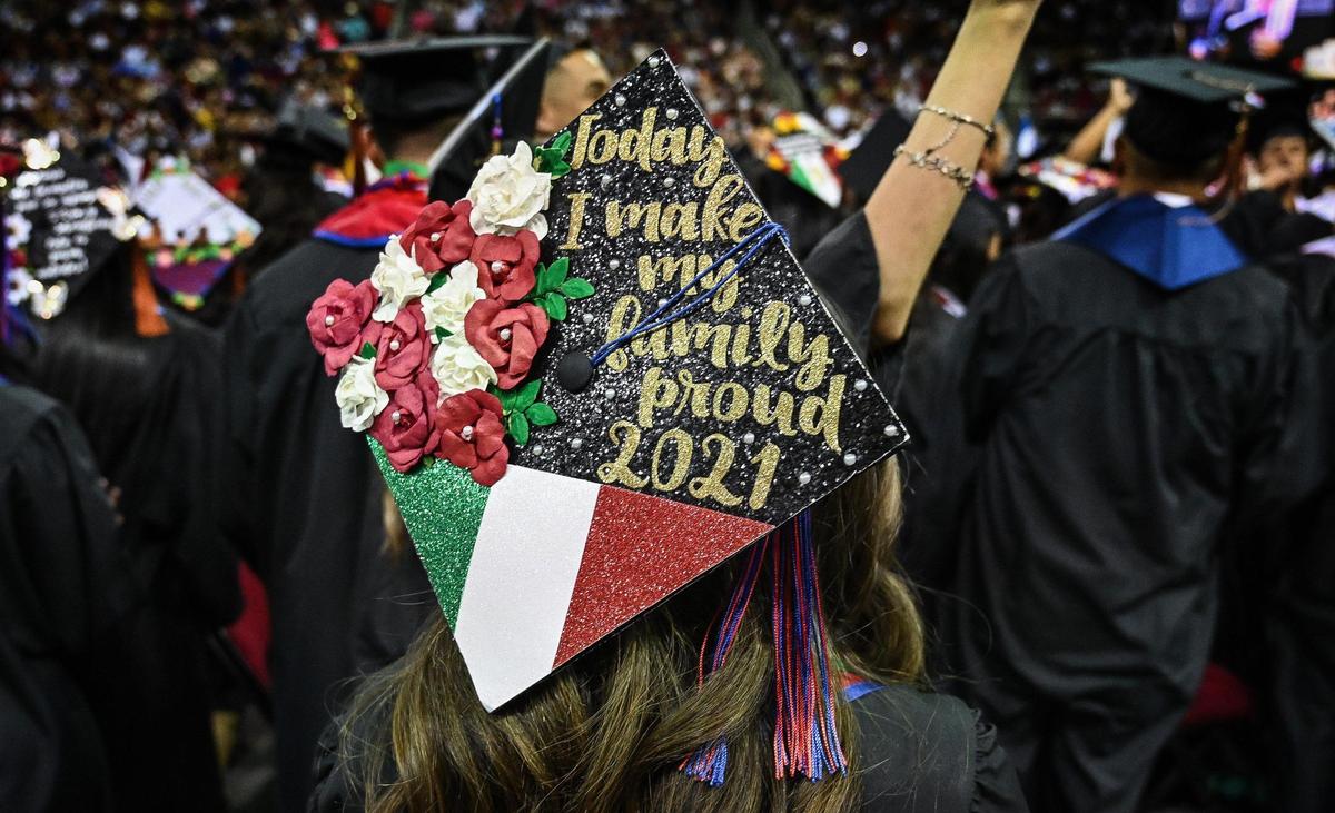 A student’s graduate cap is decorated with the words “Today I make my fairly proud 2021,” during the 46th annual Fresno State Chicano/Latino Commencement Ceremony held at the Save Mart Center on Saturday, May 21, 2022.