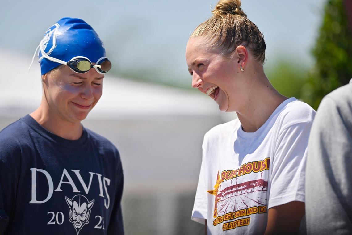 First place winner Sarah Bennetts from Davis High, left, laughs with second place winner Clovis West’s Hannah Marinovich, right, after the 100 breaststroke at the CIF swimming and diving state championships on Saturday, May 13, 2023 in Fresno.