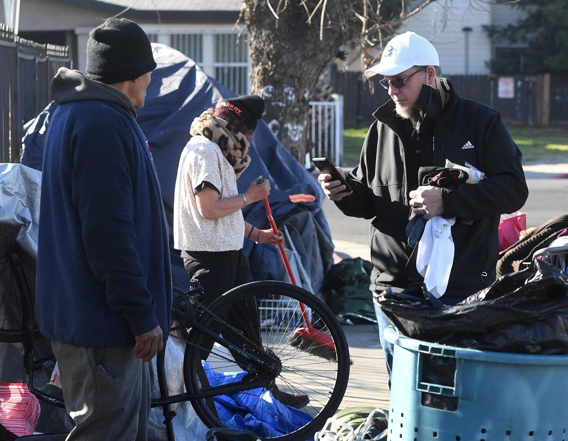 Volunteer Shawn Jenkins conducts a Point in Time count survey for the Fresno Madera Continuum of Care in a homeless encampment in the Tower District, Feb. 25, 2022.