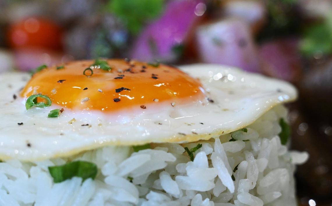 A fried egg tops jasmine rice on the lomo saltado, a traditional Peruvian dish at chef Rob Vieira and Andrew Penn’s new The Third Place Global Eatery located along Pollasky Ave. in Clovis.