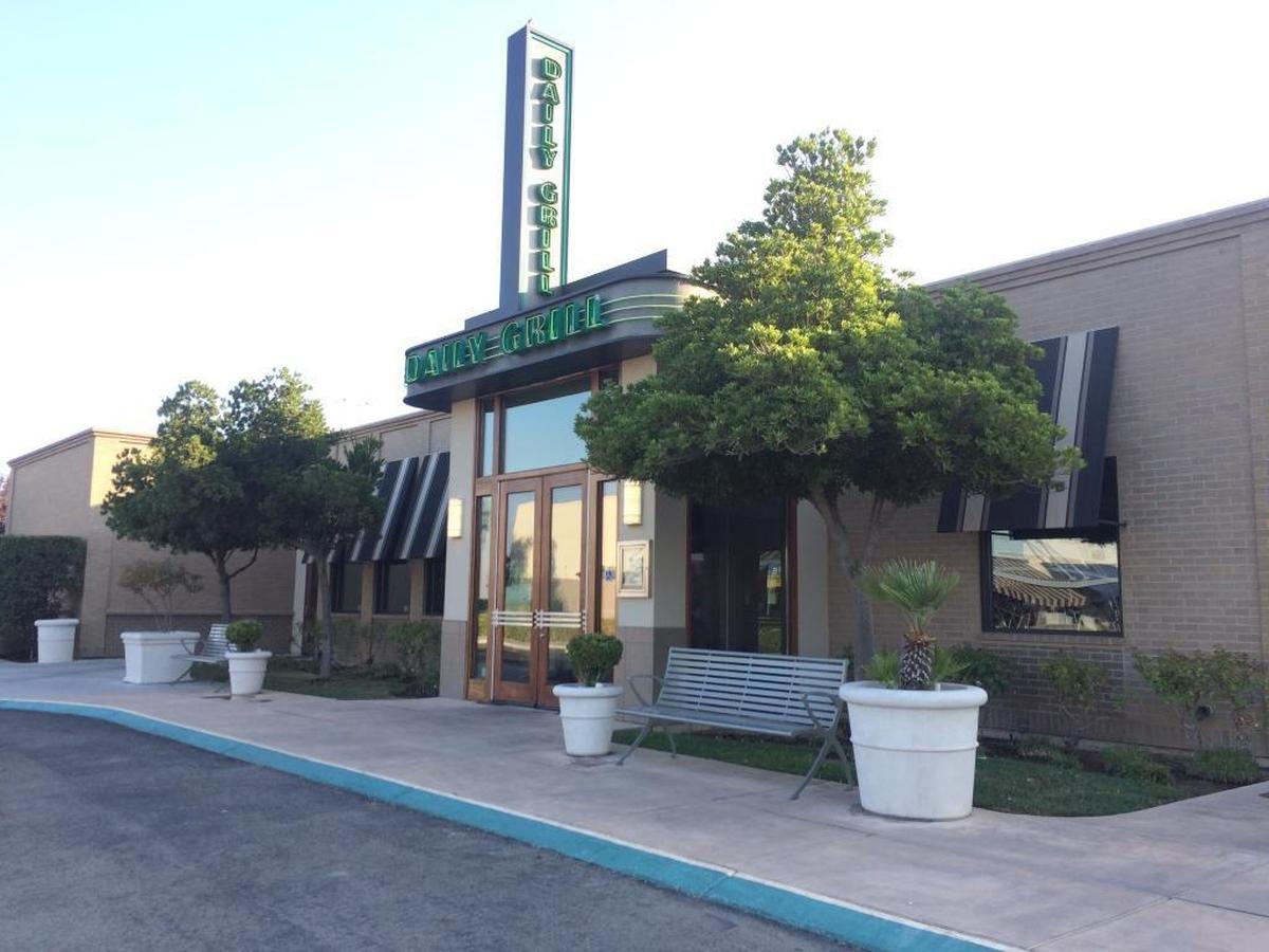 Daily Grill Restaurant at Palm and Nees avenues is pictured in in 2017 shortly after it closed. Its neon green sign has been removed and work is starting on the building to prepare it for a new tenant.