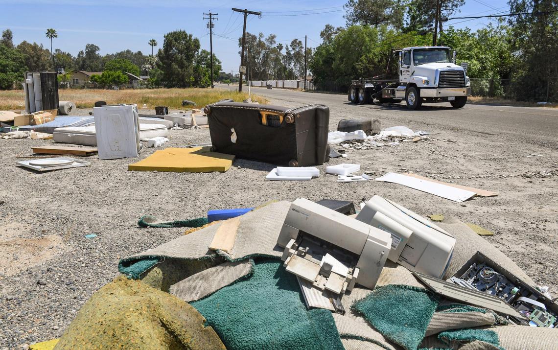 An illegal dump, including appliances, mattresses, computer equipment, furniture and chemical containers, is shown strewn along the roadside at the corner of McKinley Avenue at Bryan west of Fresno on Friday, April 30, 2021.