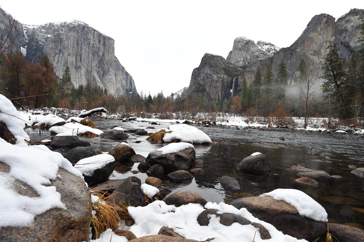 The Merced River creates a wintery scene as it lazily flows through Yosemite Valley past landmarks El Capitan, left, and Bridal Veil Falls, right center, Tuesday, Dec. 4, 2018.
