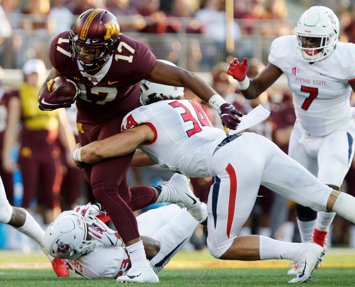 Fresno State linebacker George Helmuth (34) and safety Juju Hughes (23) take down Minnesota wide receiver Seth Green (17) is tackled as James Bailey (7) closes on the play in the Bulldogs’ 21-14 loss to the Golden Gophers, Saturday, Sept. 8, 2018.