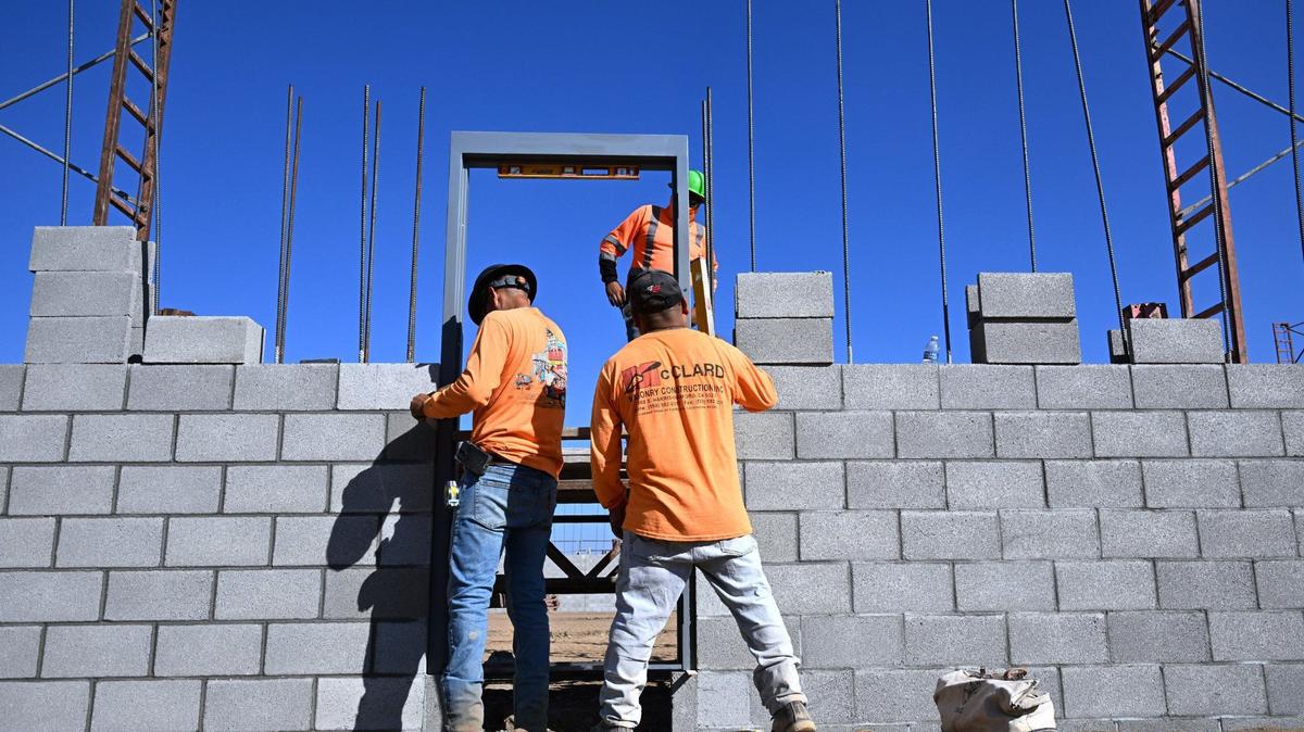 Workers install a door frame at the new Sprouts location at Fancher Creek Town Center along Clovis Avenue near Tulare Avenue. Photographed Monday, Oct. 14, 2024 in Fresno.
