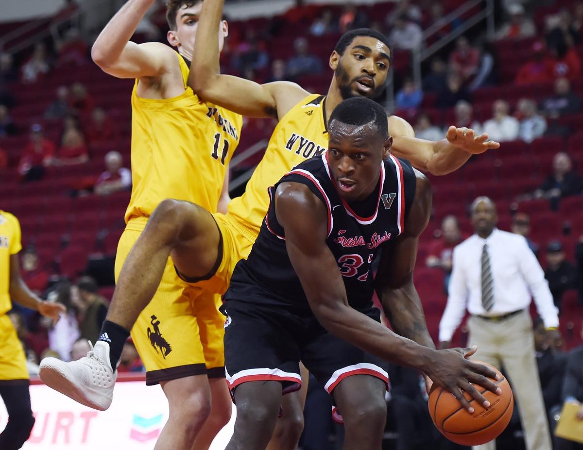 Fresno State forward Nate Grimes, center, grabs a rebound in the Bulldogs’ 71-60 victory over the Wyoming Cowboys Wednesday, Feb. 27, 2019 in Fresno. Grimes 15 points and 14 rebounds in the win, his 11th double-double and 10th in Mountain West play.
