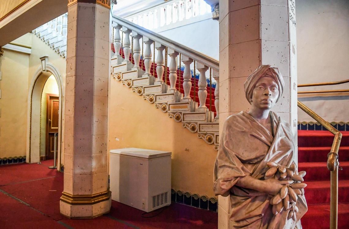 One of two marble statues stands at the foot of a grand staircase that ascends to the second floor of the Warnors Theatre in downtown Fresno on Thursday, Nov. 11, 2021.