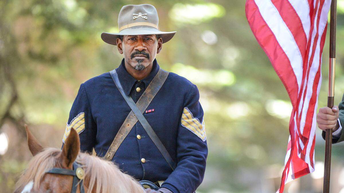 Yosemite National Park ranger Shelton Johnson wears the uniform of a Buffalo Soldier while saddled on his horse during the Yosemite Grant 150th ceremony at Yosemite National Park’s Mariposa Grove Monday, June 30, 2014. On June 30, 1864, President Abraham Lincoln signed the Yosemite Land Grant which eventually led to the national parks system.