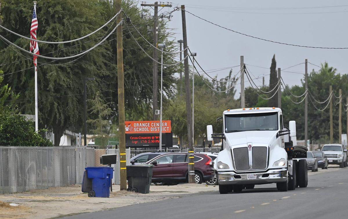 A truck passes the Orange Center School District offices along S Cherry Ave. Thursday, Sept. 18, 2025 near Fresno. A plan to rezone the area allowing more trucking has residents and school officials concerned for safety