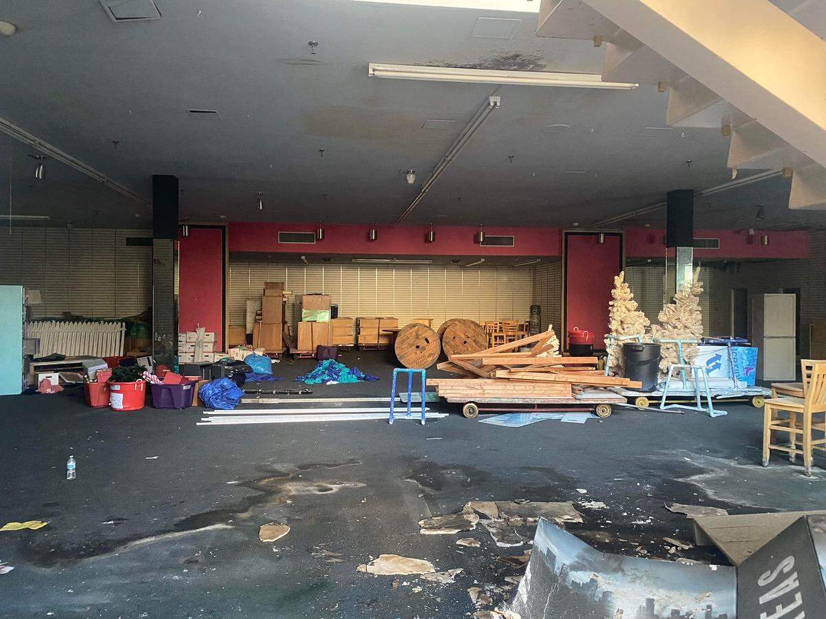 A peek inside the Berkeley’s building at 887 Fulton Street in downtown Fresno, California, taken Dec. 1, 2021, through an opening in a boarded up window. Bollards purchased for the 2017 Fulton Street reopening were stored here by the Downtown Fresno Partnership. The bollards were never used and have since gone missing.