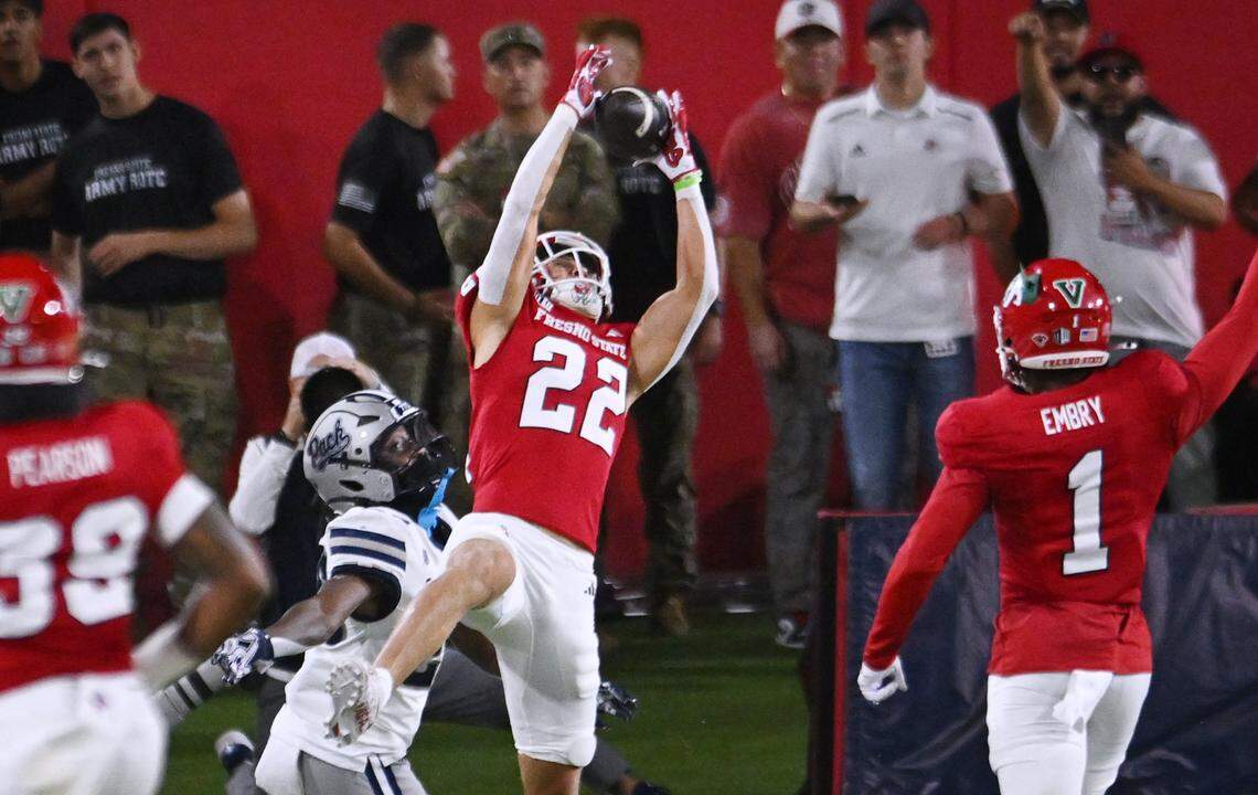 Fresno State defensive back Camryn Bracha, center, intercepts a pass intended for Nevada's Joe Birnbaum during the first half Saturday, Oct. 4, 2025 in Fresno.