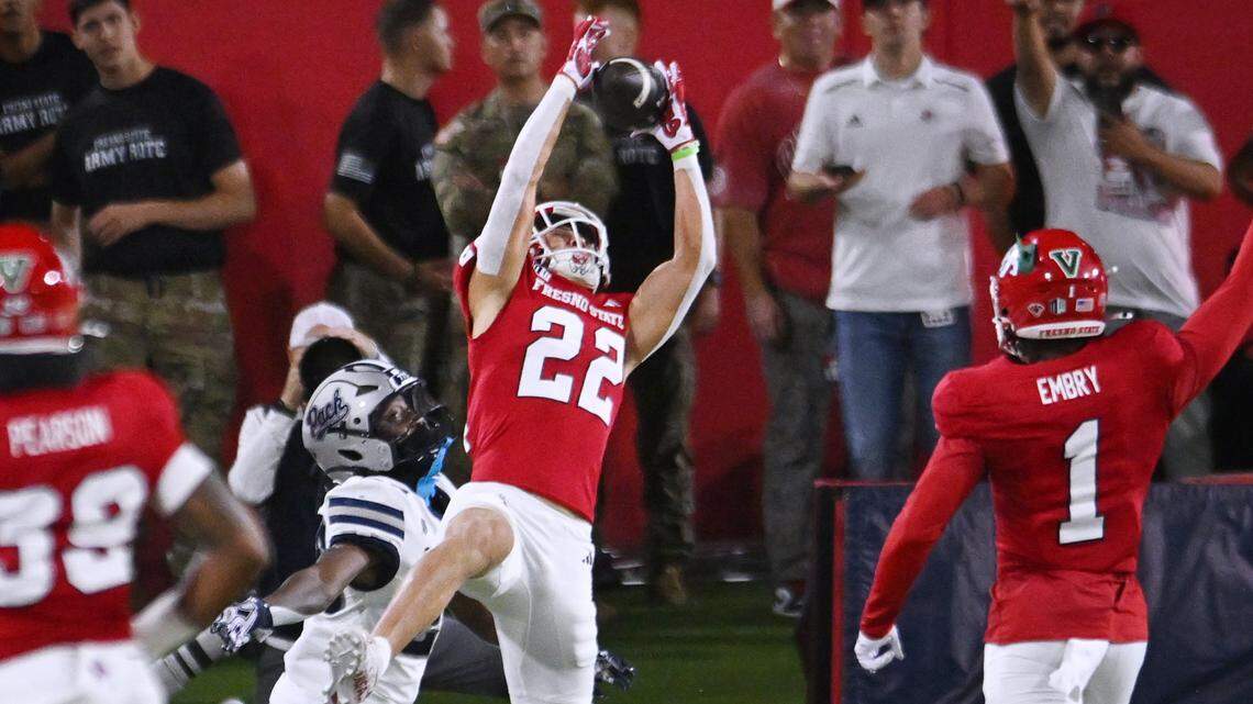 Fresno State defensive back Camryn Bracha, center, intercepts a pass intended for Nevada's Joe Birnbaum during the first half Saturday, Oct. 4, 2025 in Fresno.